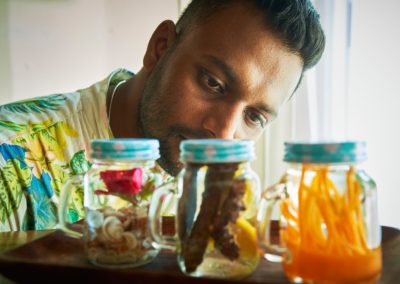 munjoh team-a waiter looking at the coctails in jars