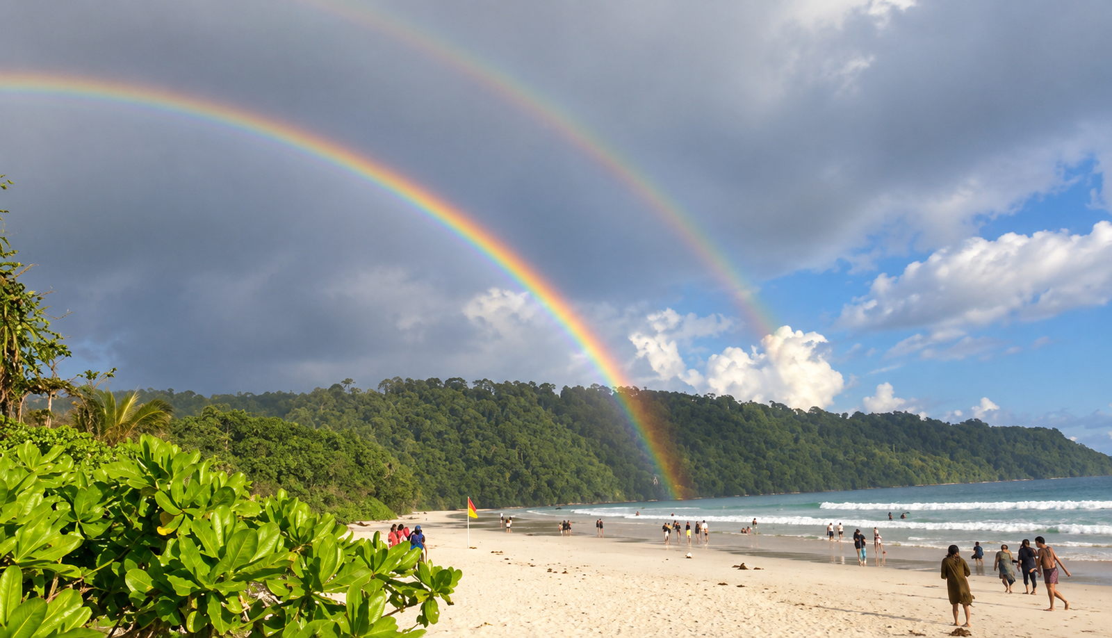 Two rainbows on the horizon and greenery in the front along with the pristine Radhanagar beach near Munjoh Ocean Resort, Havelock Island