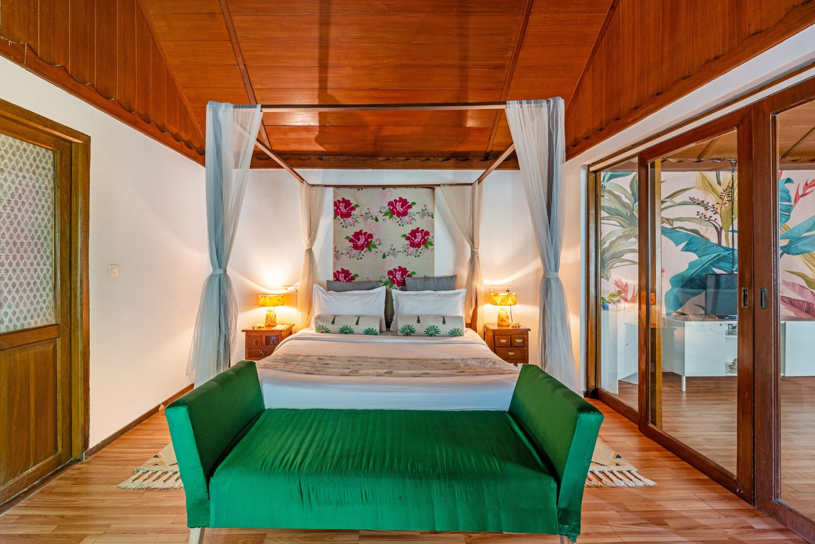 Four-poster Ocean Suite bedroom seen from its separate lounge at Munjoh Ocean Resort on Havelock Island
