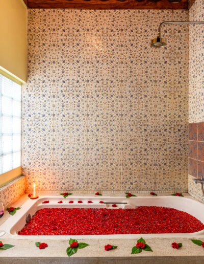 Deep flower-filled bathtub in the Ocean Suite bathroom at Munjoh Ocean Resort on Havelock Island