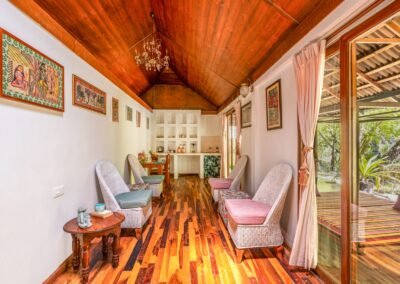 Wood-panelled lounge leading to the dining area inside the Royal Chalet at Munjoh Ocean Resort