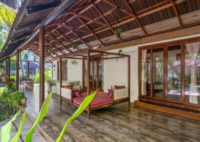 Shaded wrap-around verandah with seating at the Royal Chalet