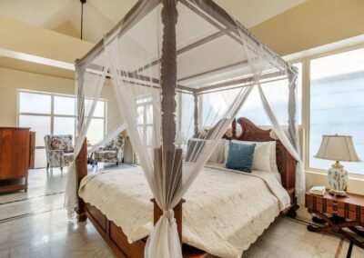 Jade Suite four-poster bedroom with wide windows at Munjoh Island House in Port Blair