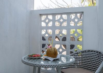 Private patio with table, chairs and fresh coconut in the Jade Suite at Munjoh Island House